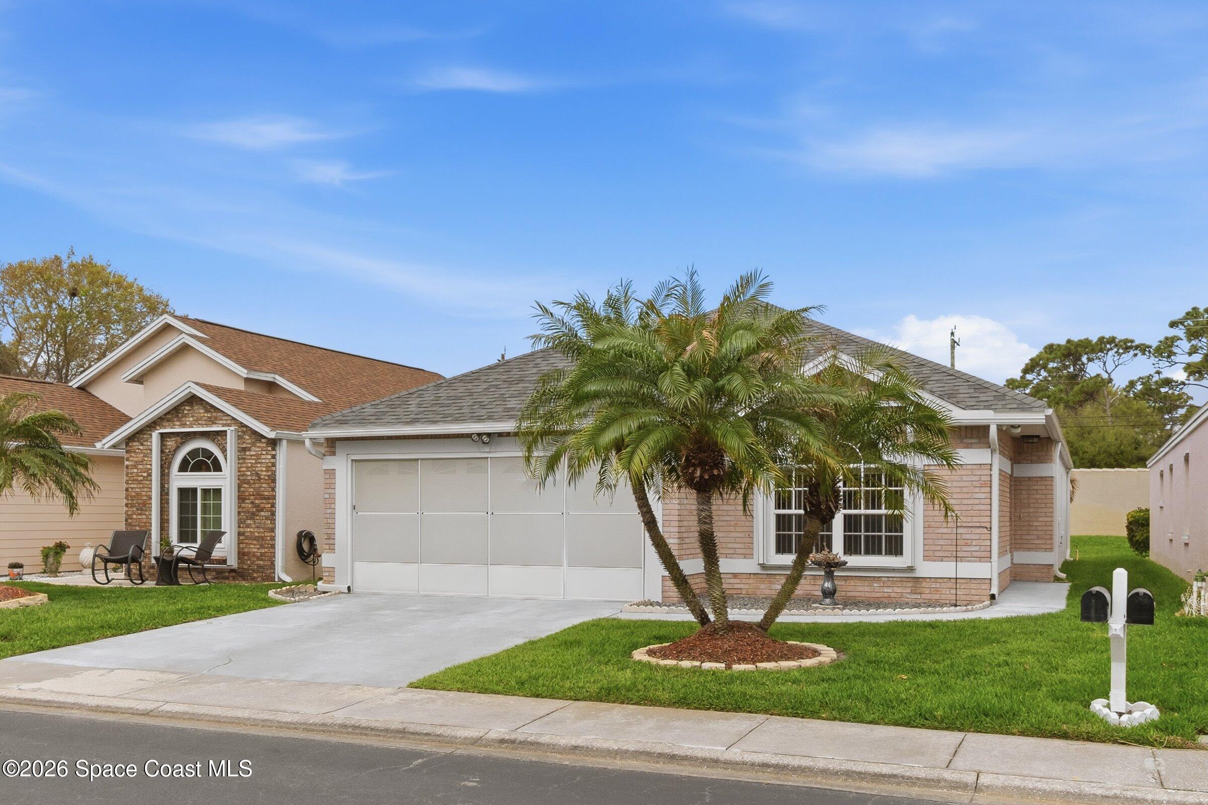 934 South Fork Circle Melbourne, FL 32901 - Photo 2 of 60 a front view of a house with a garden and yard