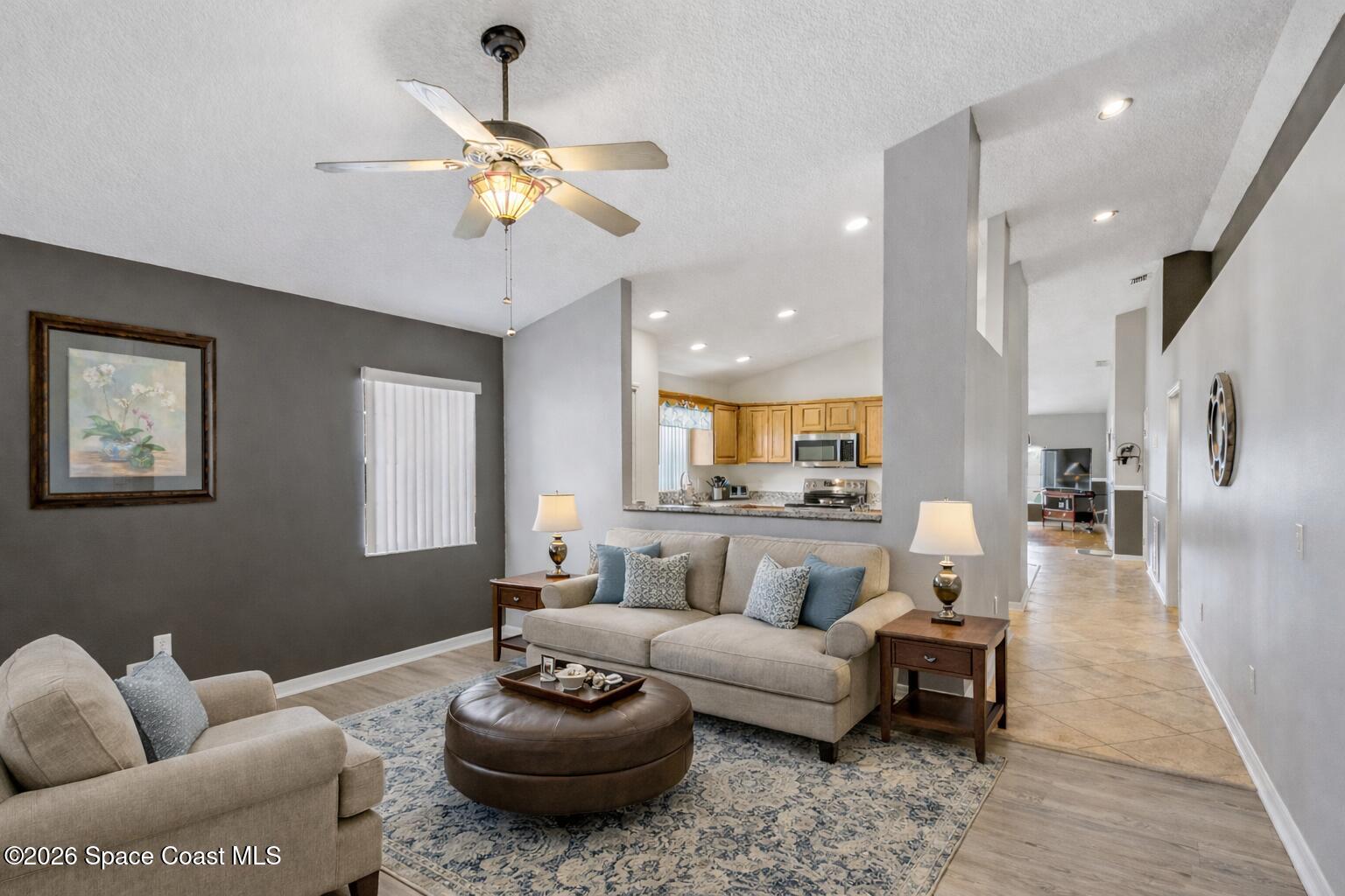 934 South Fork Circle Melbourne, FL 32901 - Photo 22 of 60 a living room with furniture and a chandelier