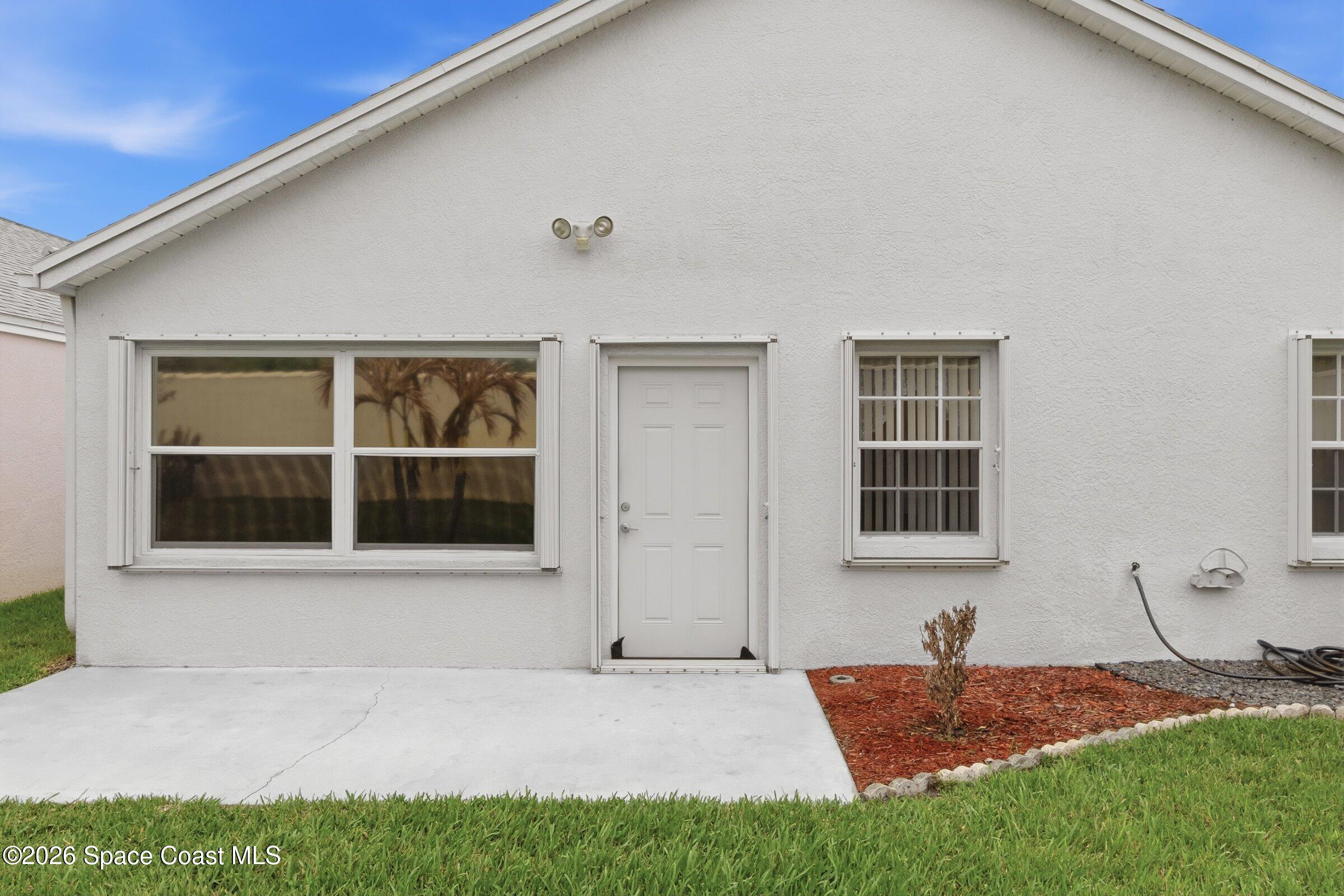 934 South Fork Circle Melbourne, FL 32901 - Photo 30 of 60 a front view of a house with a yard