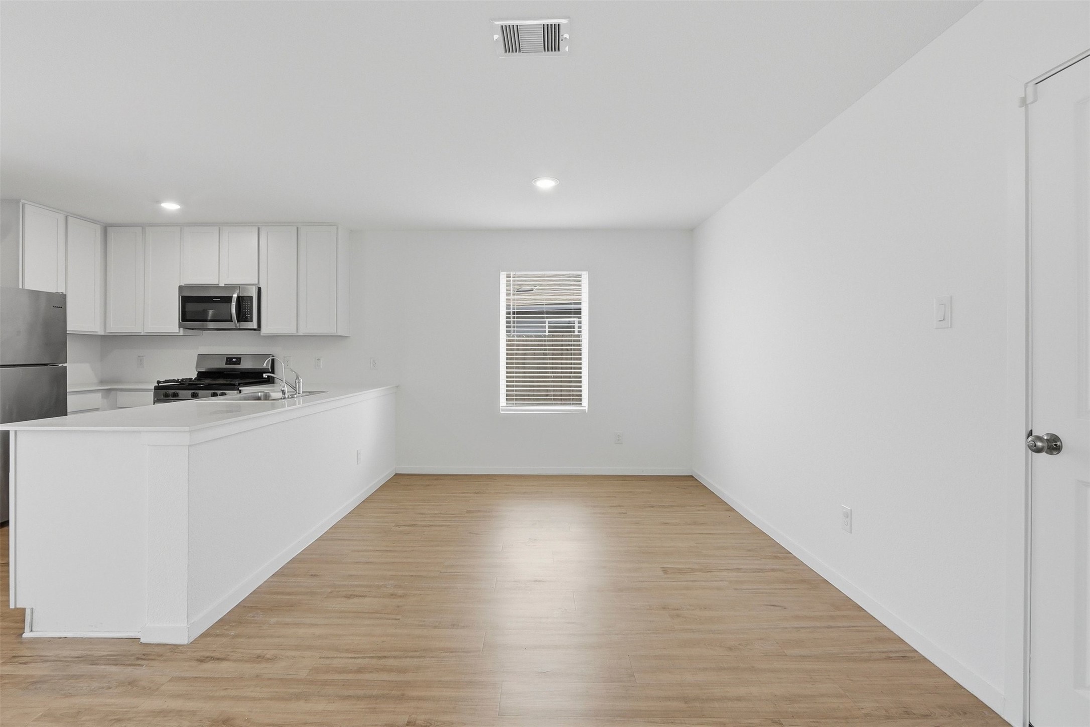 21006 Longwitton Lane Humble, TX 77338 - Photo 6 of 25 a kitchen with granite countertop white cabinets and white appliances