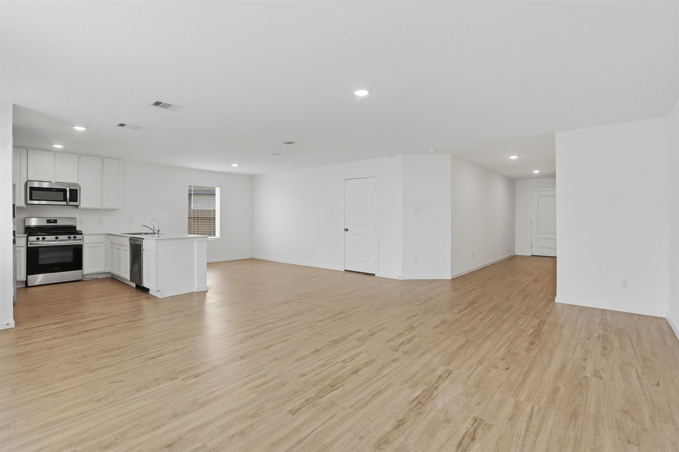 21006 Longwitton Lane Humble, TX 77338 - Photo 8 of 25 a view of empty room with wooden floor