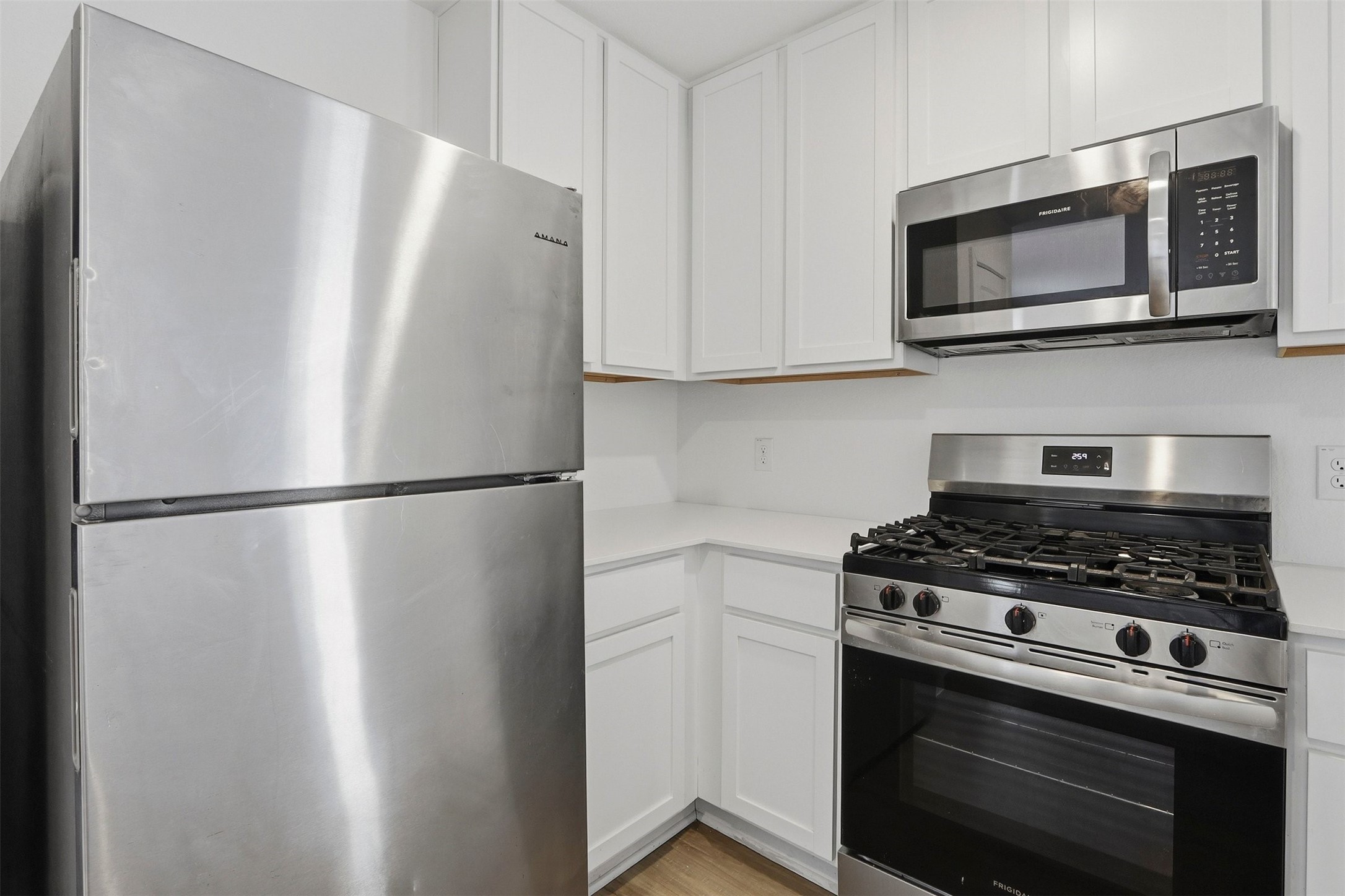 21006 Longwitton Lane Humble, TX 77338 - Photo 10 of 25 a kitchen with stainless steel appliances a refrigerator stove and microwave