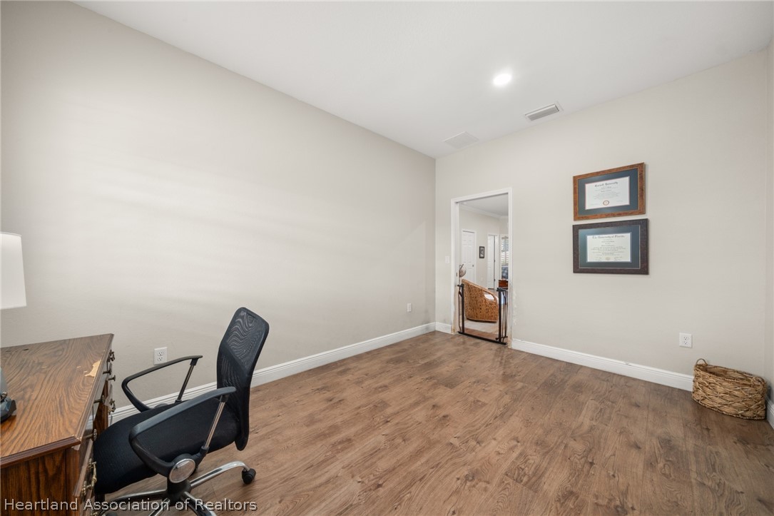 4734 Haw Branch Road, Unit 110 Sebring, FL 33875 - Photo 33 of 50 a view of a workspace with furniture and wooden floor