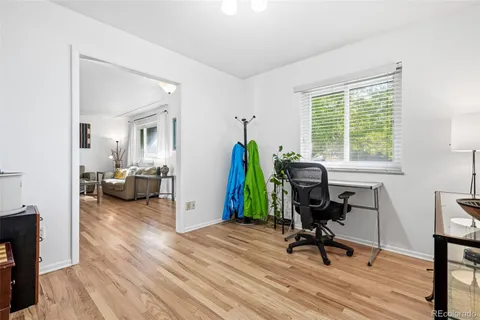 a view of a workspace with furniture and a window