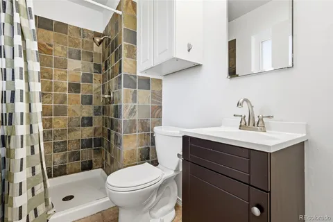 a bathroom with a sink toilet and shower