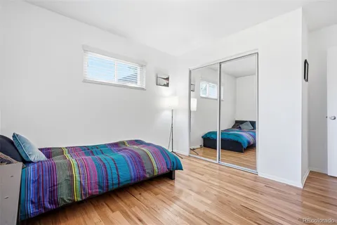 a bedroom with a bed and a chair