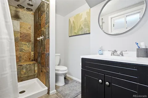 a bathroom with a sink mirror vanity and toilet