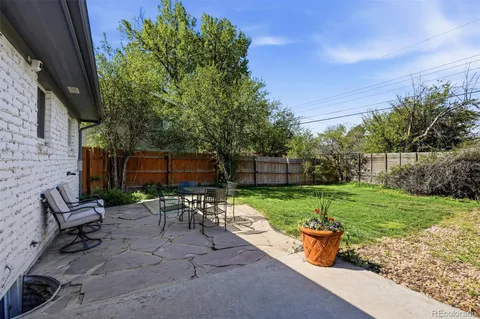 a view of a backyard with sitting area furniture and garden
