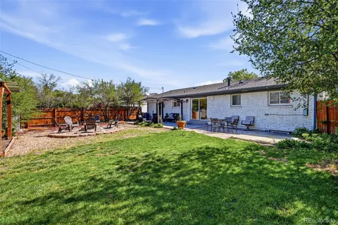 a backyard of a house with table and chairs