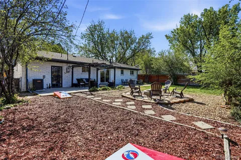 a backyard of a house with table and chairs