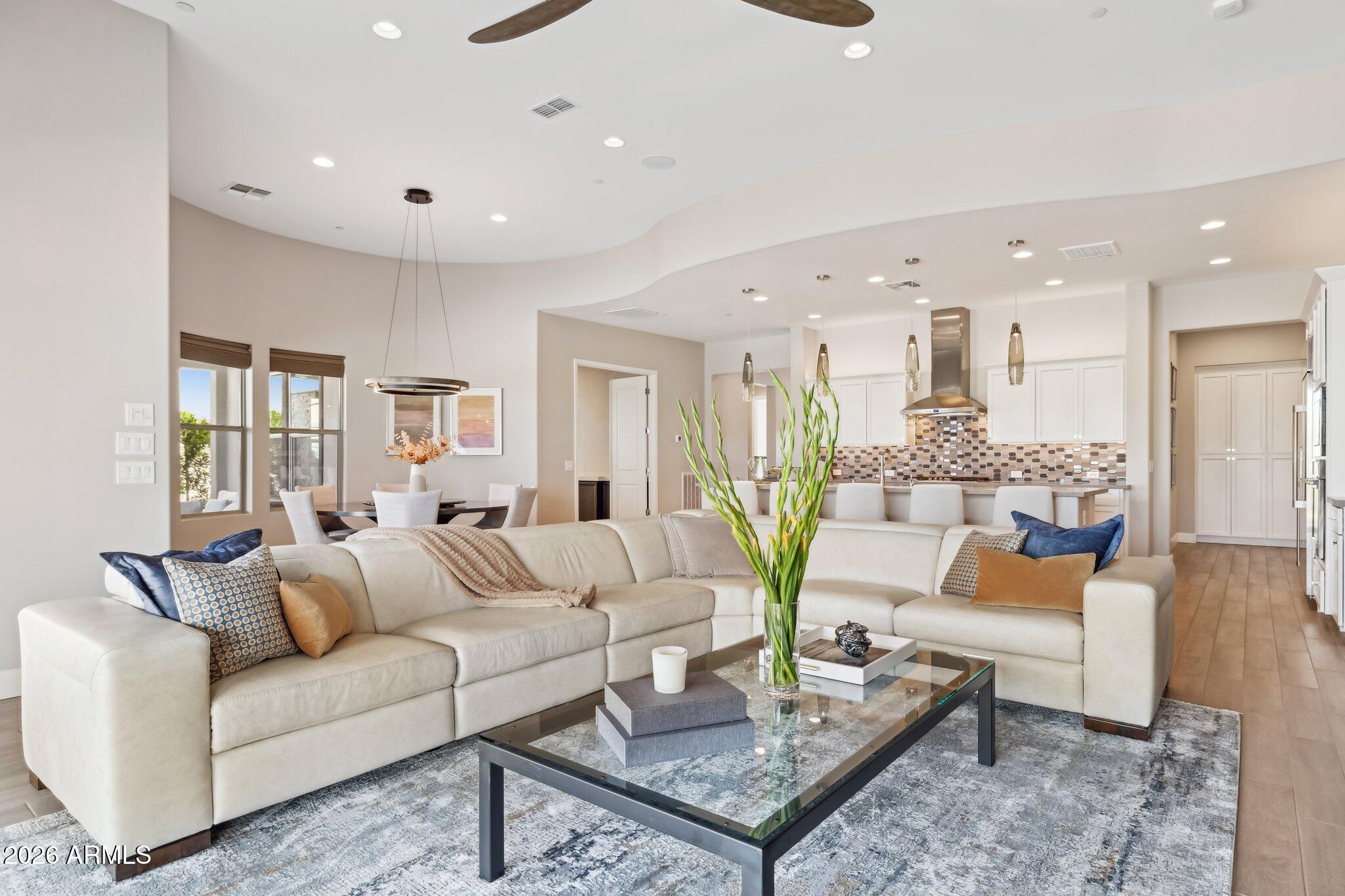 17964 East Wolf Tree Lane Rio Verde, AZ 85263 - Photo 9 of 101 a living room with furniture and a wooden floor