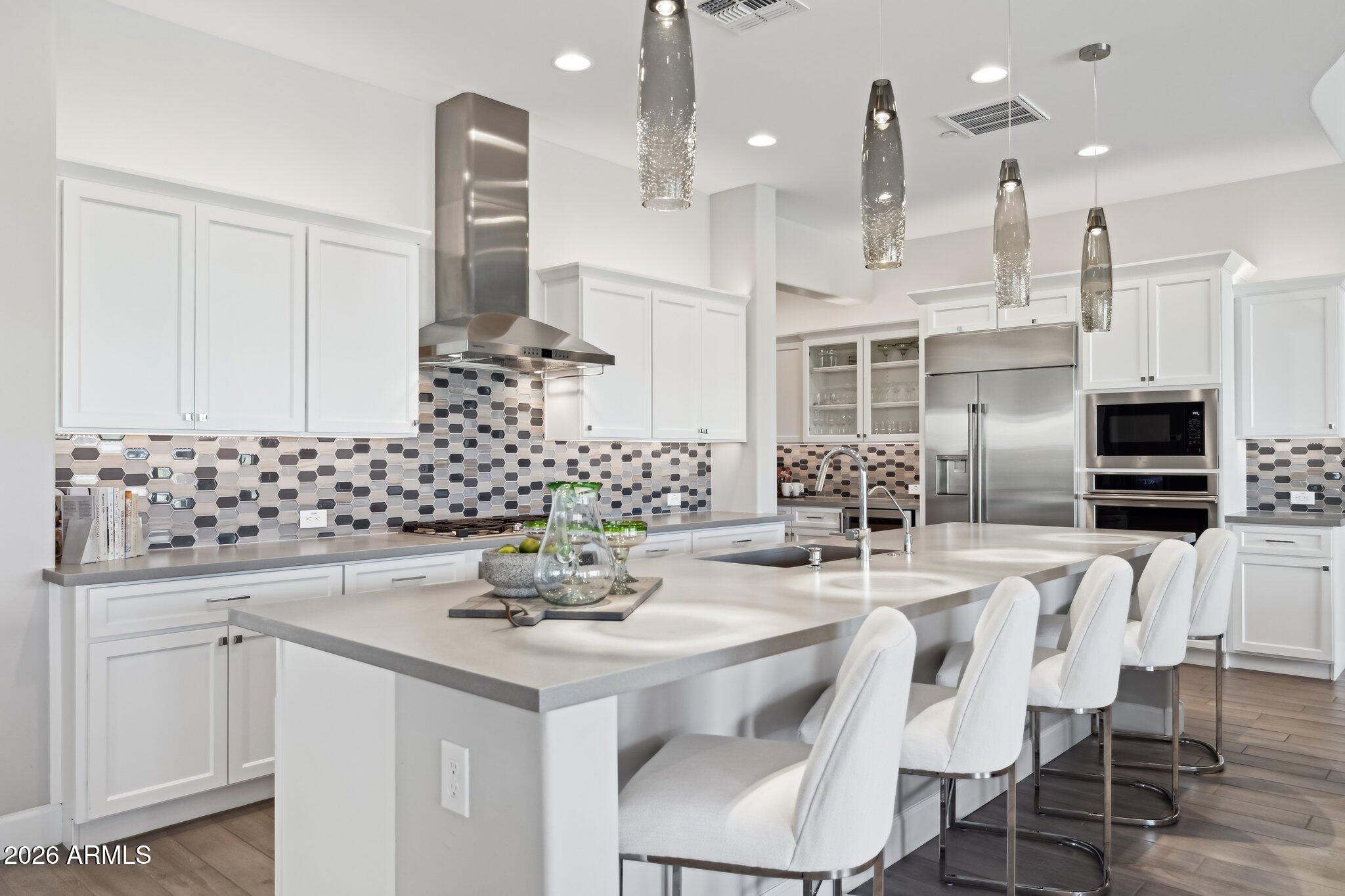 17964 East Wolf Tree Lane Rio Verde, AZ 85263 - Photo 12 of 101 a kitchen with stainless steel appliances kitchen island granite countertop a sink and cabinets