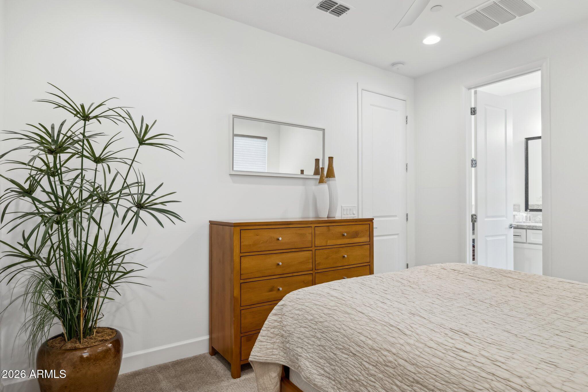 17964 East Wolf Tree Lane Rio Verde, AZ 85263 - Photo 30 of 101 a bedroom with a bed and a potted plant
