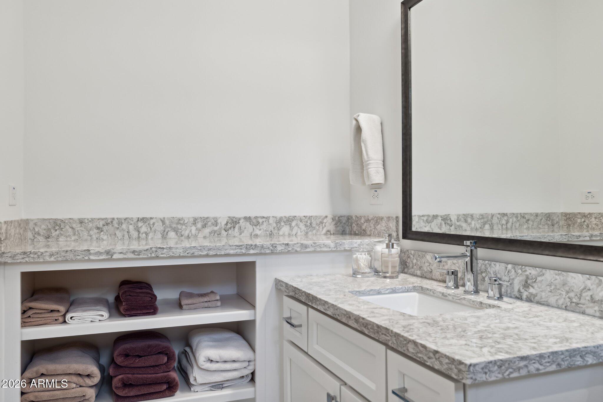 17964 East Wolf Tree Lane Rio Verde, AZ 85263 - Photo 31 of 101 a bathroom with a granite countertop sink and a mirror