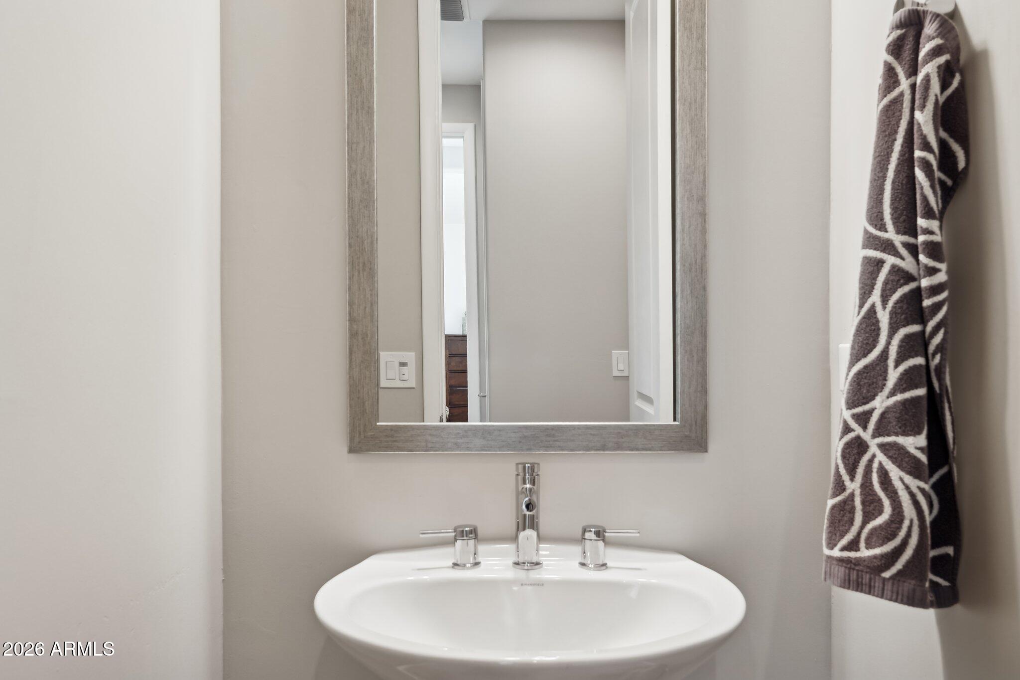 17964 East Wolf Tree Lane Rio Verde, AZ 85263 - Photo 41 of 101 a bathroom with a sink and a mirror