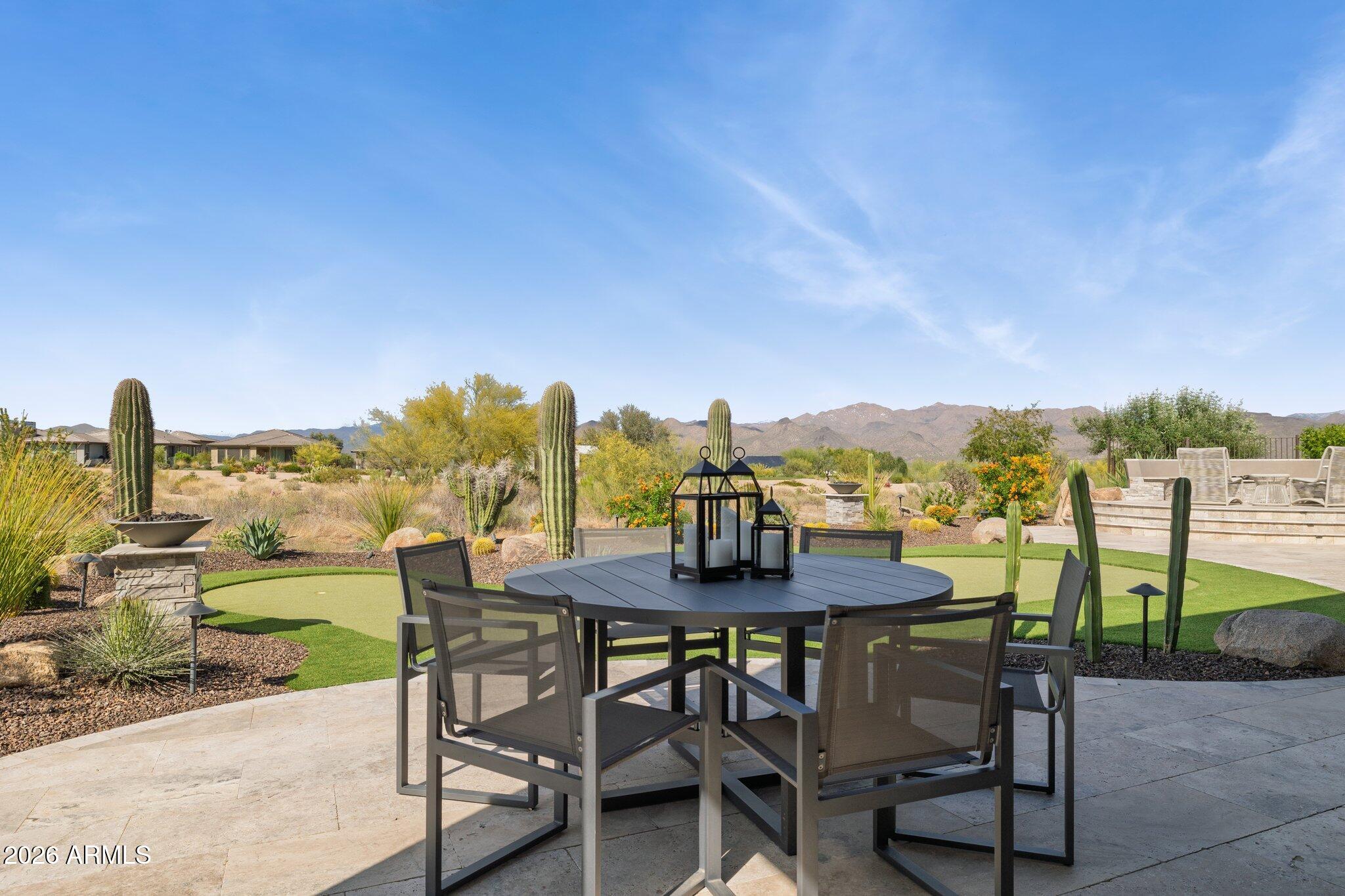 17964 East Wolf Tree Lane Rio Verde, AZ 85263 - Photo 53 of 101 a view of a patio with a table and chairs