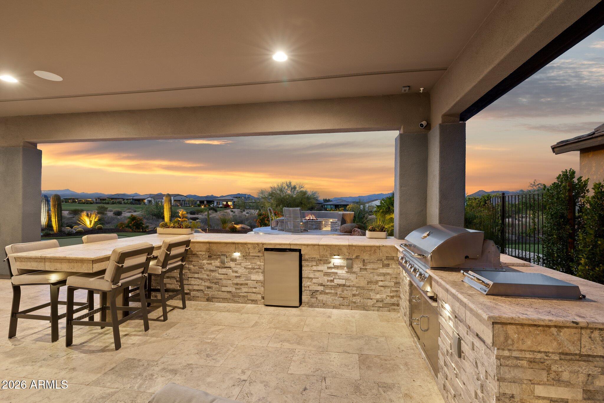 17964 East Wolf Tree Lane Rio Verde, AZ 85263 - Photo 59 of 101 a view of a terrace with furniture and a yard