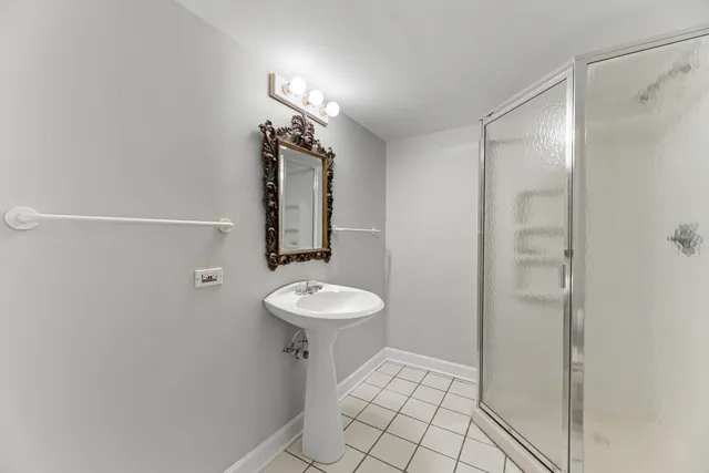 a front view of a house with a yard and potted plants