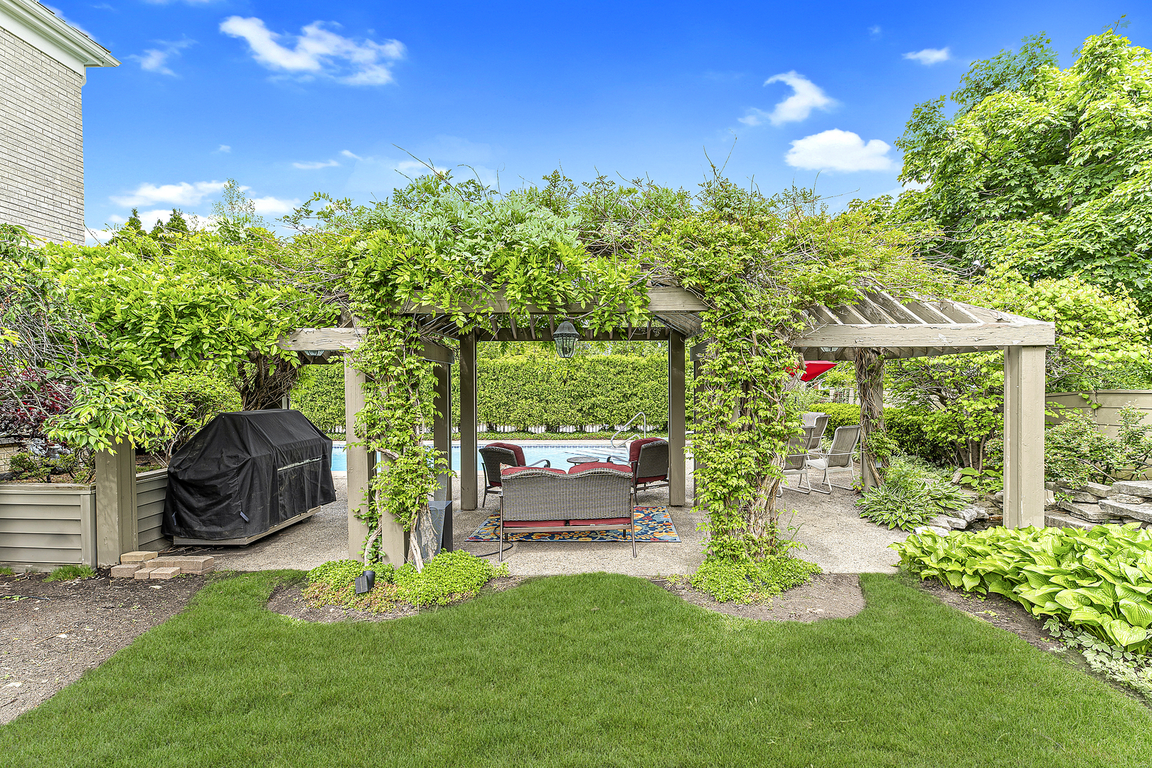 2308 Indian Ridge Drive Glenview, IL 60026 - Photo 52 of 60 a backyard of a house with table and chairs potted plants and large tree