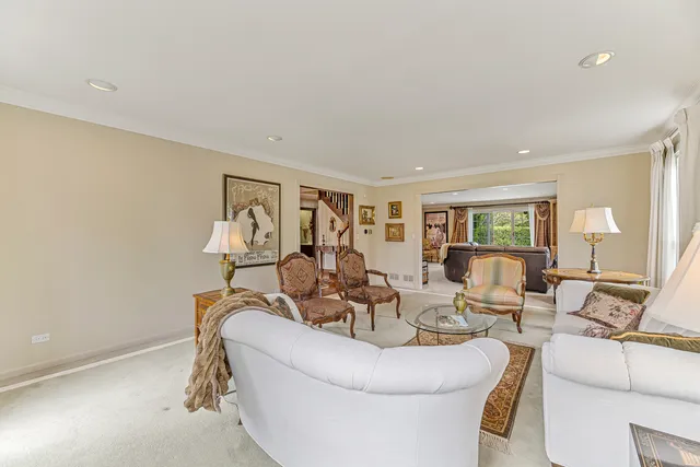 a large kitchen with stainless steel appliances granite countertop a stove and a view of living room