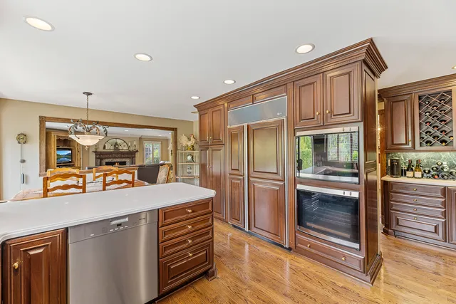 a kitchen with stainless steel appliances granite countertop a stove a sink dishwasher and a microwave oven with cabinets