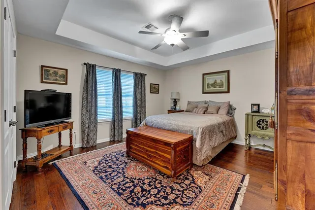 a bathroom with a granite countertop double vanity and a mirror
