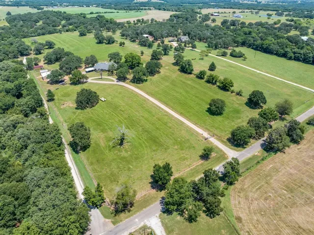 an aerial view of a residential houses with outdoor space and swimming pool