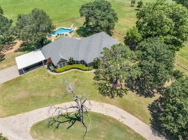 a aerial view of a house with a yard