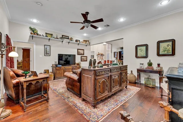a living room with furniture ceiling fan and a rug