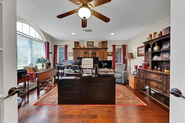 a living room with furniture and wooden floor