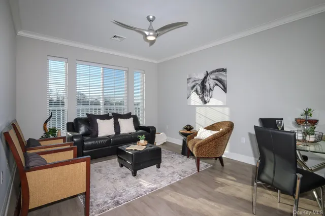 a living room with furniture and large windows