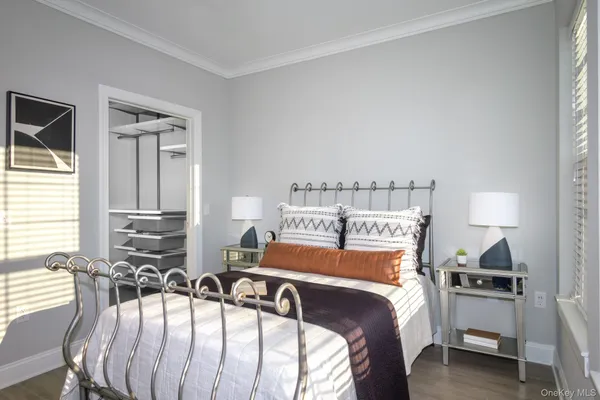 a bedroom with two beds and a chair