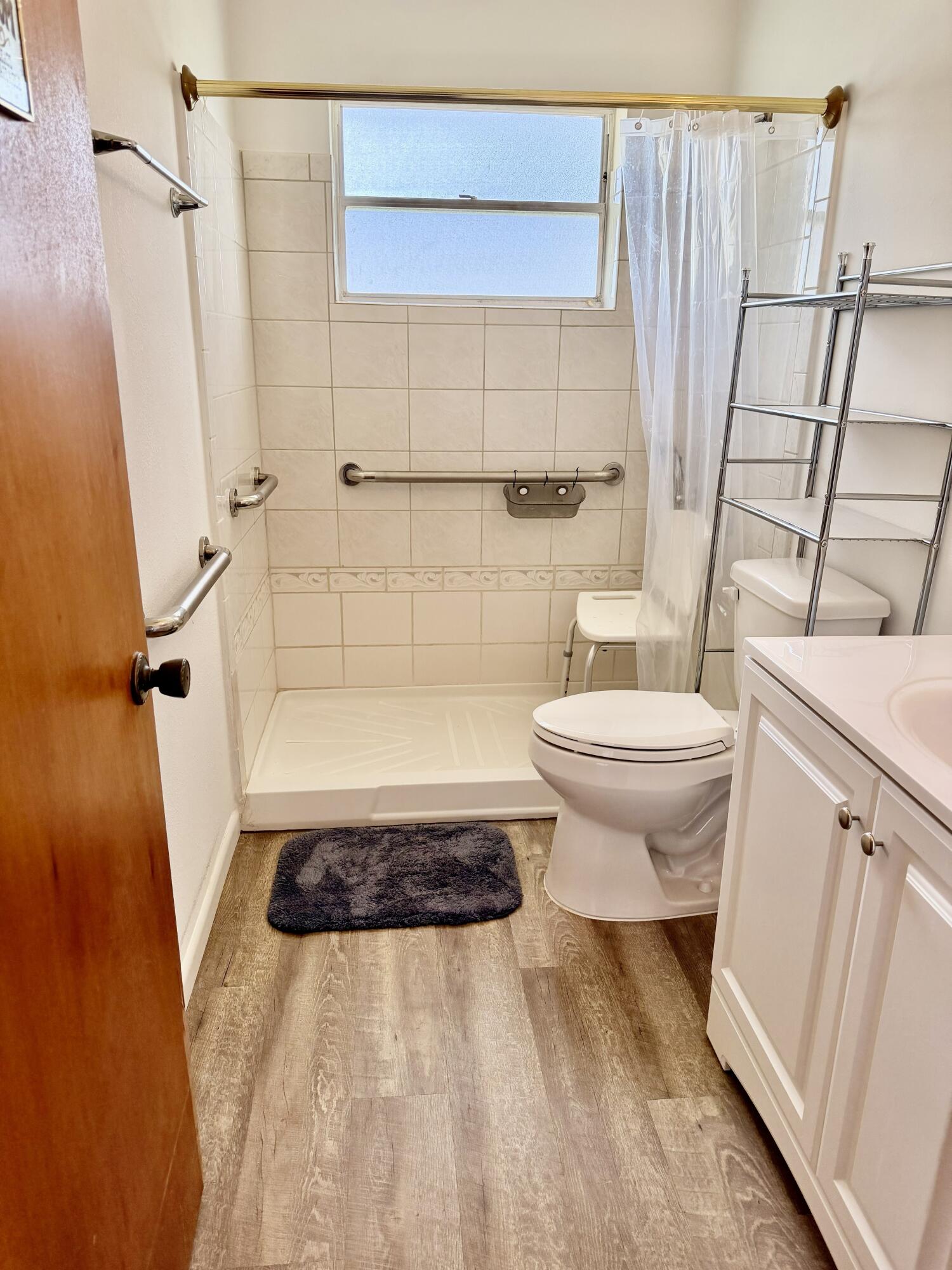 3283 Southwest 20th Street Okeechobee, FL 34974 - Photo 12 of 19 a bathroom with a sink a toilet a mirror and shower