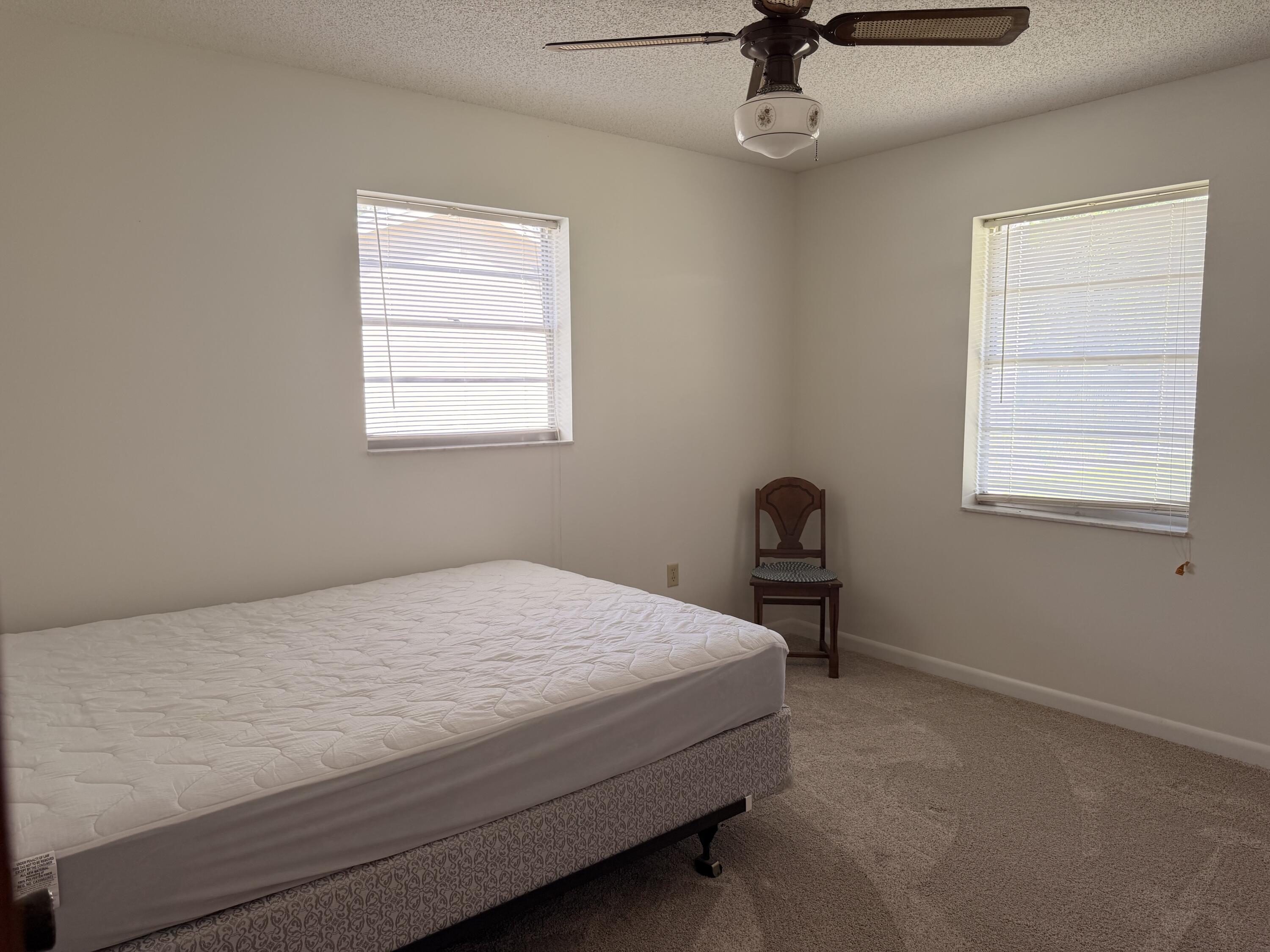3283 Southwest 20th Street Okeechobee, FL 34974 - Photo 14 of 19 a bedroom with a bed and a window