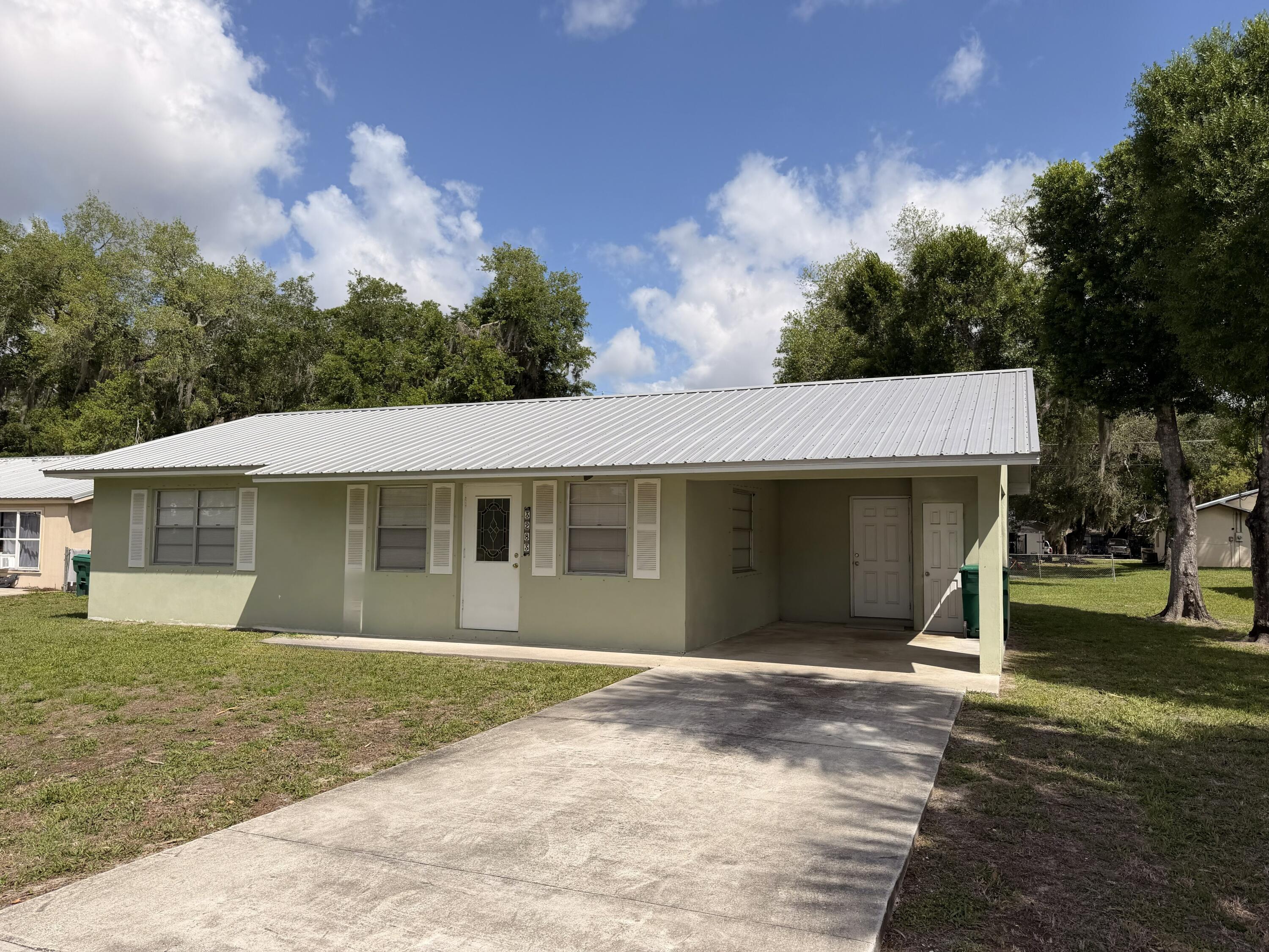 3283 Southwest 20th Street Okeechobee, FL 34974 - Photo 17 of 19 front view of a house with a yard
