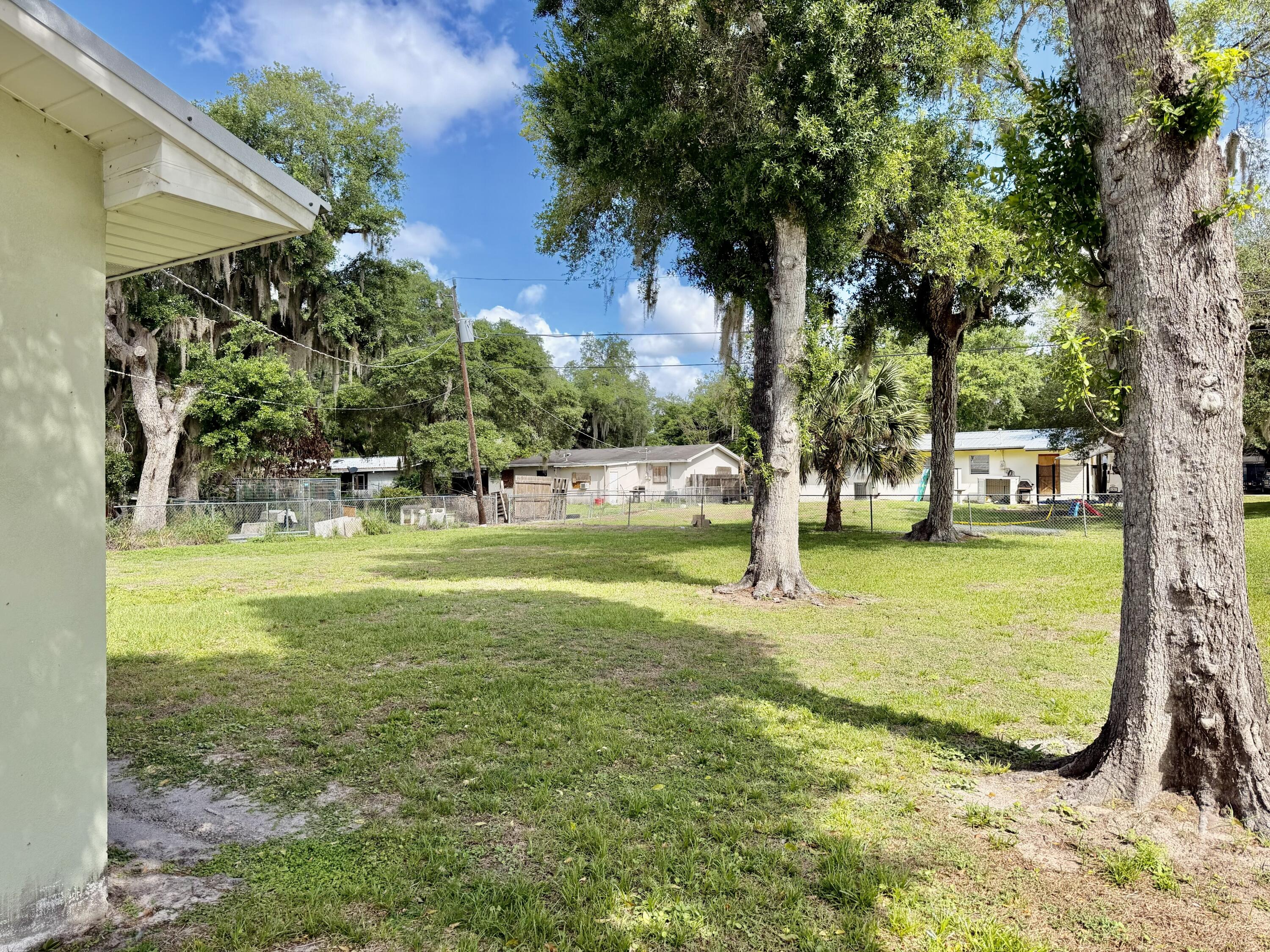 3283 Southwest 20th Street Okeechobee, FL 34974 - Photo 18 of 19 a view of yard with swimming pool and trees