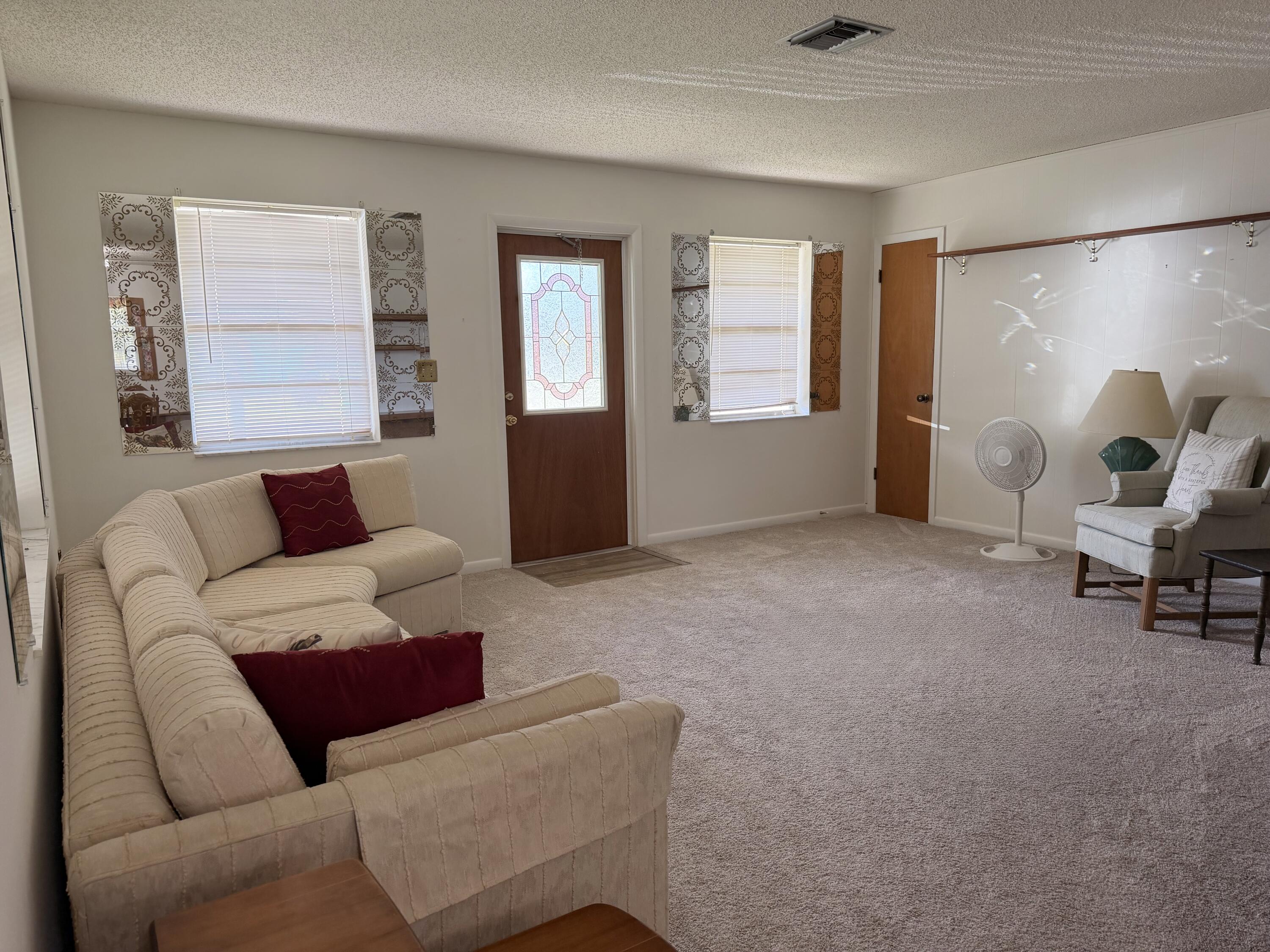 3283 Southwest 20th Street Okeechobee, FL 34974 - Photo 3 of 19 a living room with furniture and a window