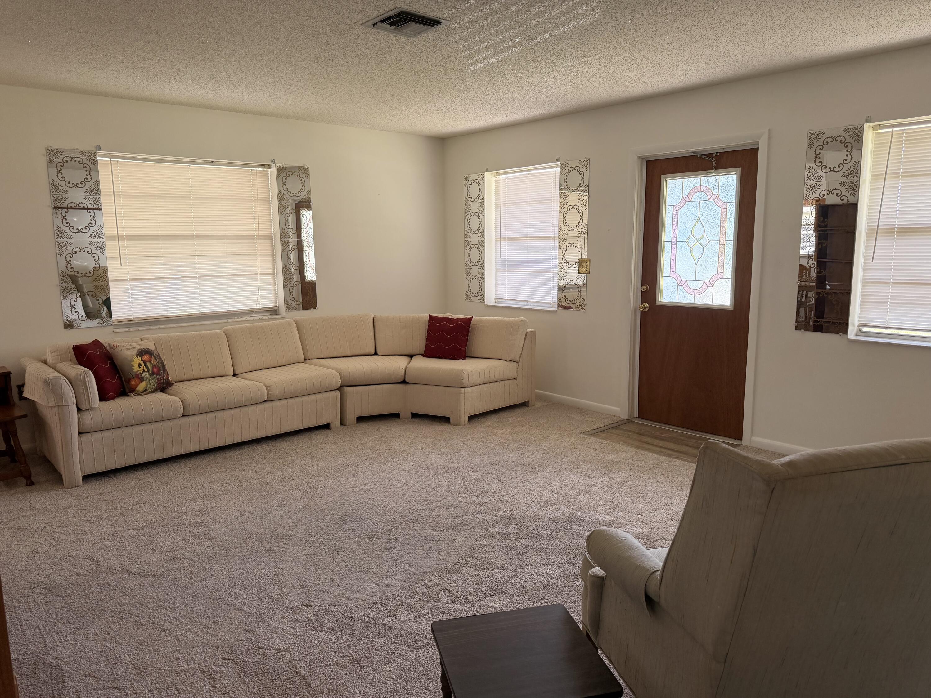 3283 Southwest 20th Street Okeechobee, FL 34974 - Photo 4 of 19 a living room with furniture and a window