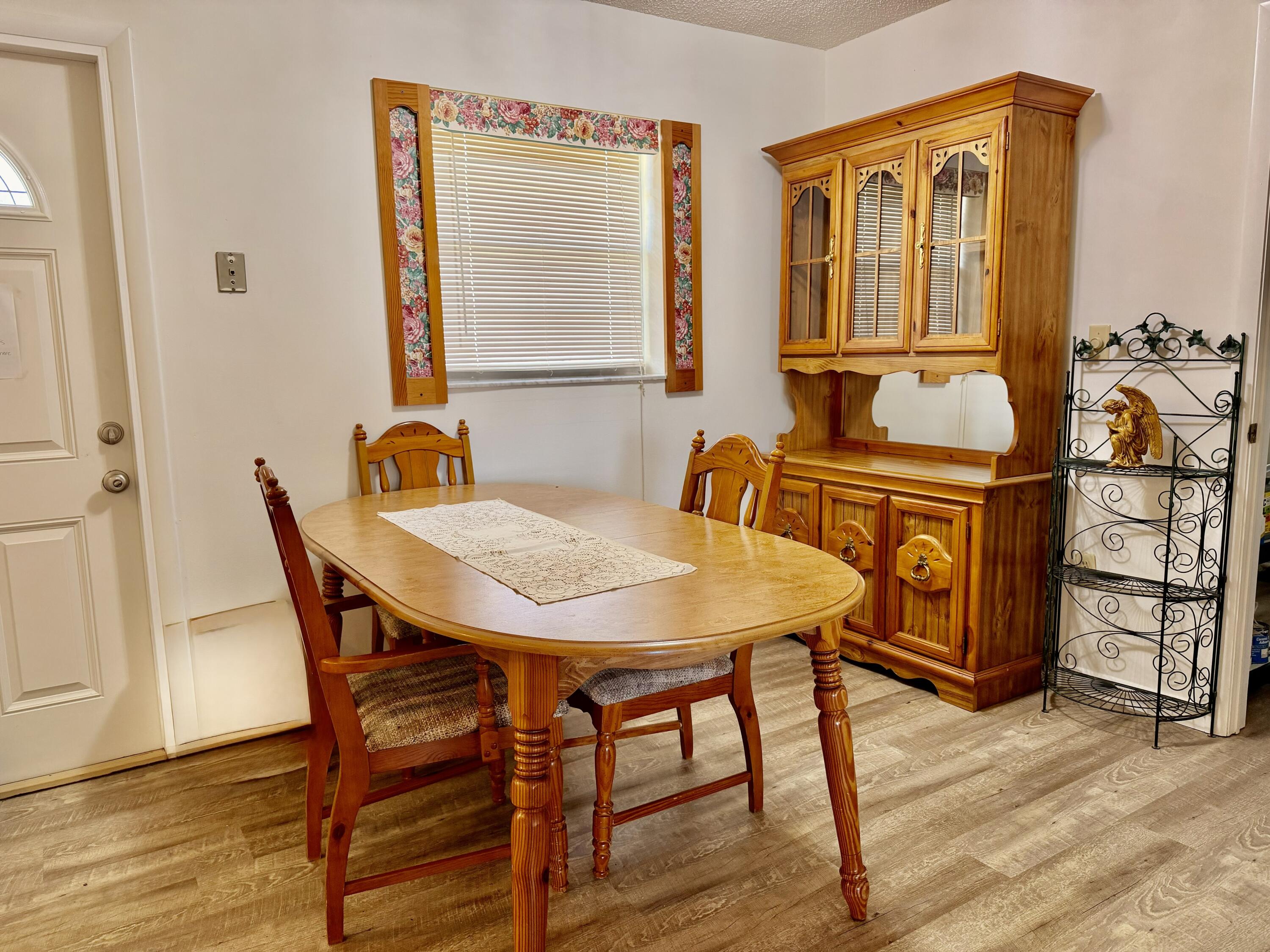 3283 Southwest 20th Street Okeechobee, FL 34974 - Photo 7 of 19 a view of a a dining room with furniture window and wooden floor