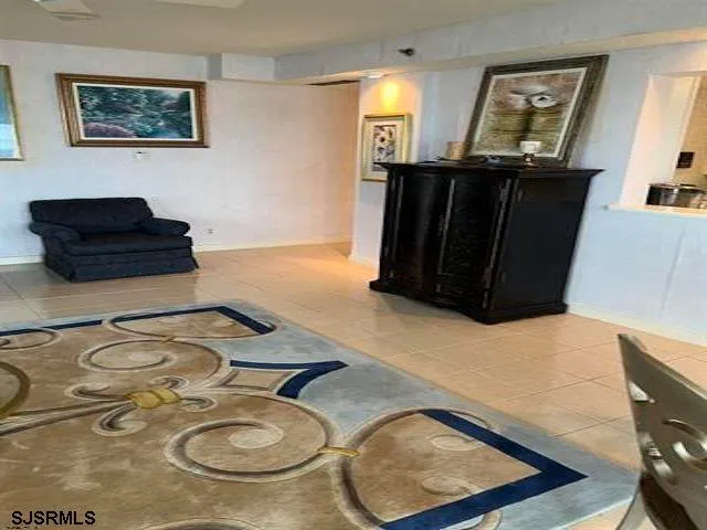 a dining table chair with granite countertop a sink and a mirror