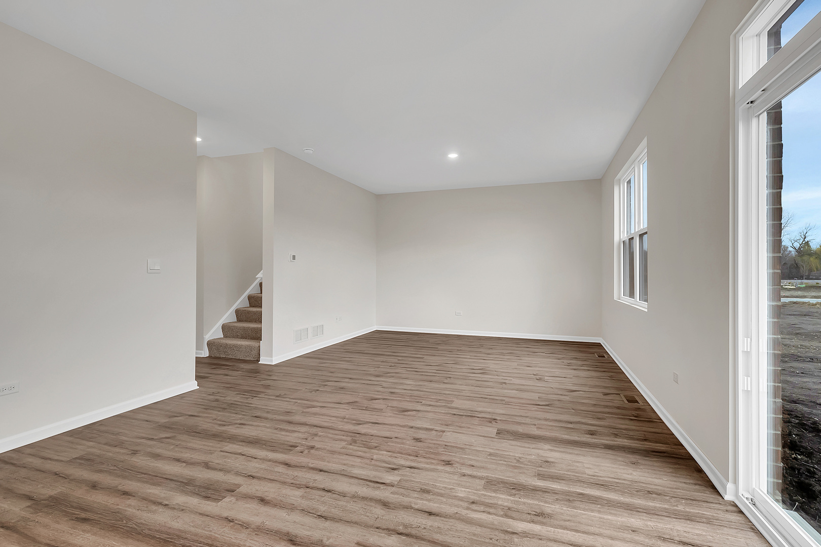 6720 Applegate Drive Plainfield, IL 60586 - Photo 11 of 17 a view of an empty room with wooden floor and a window