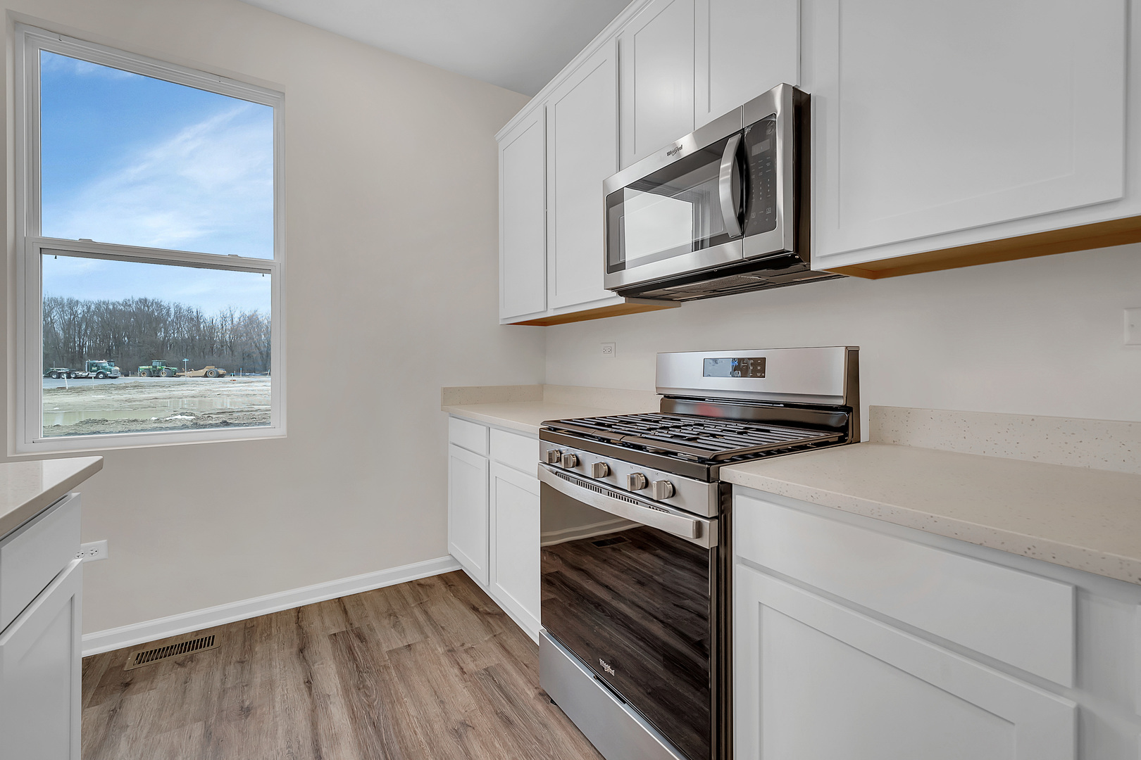 6720 Applegate Drive Plainfield, IL 60586 - Photo 4 of 17 a kitchen with stainless steel appliances white cabinets and a stove top oven