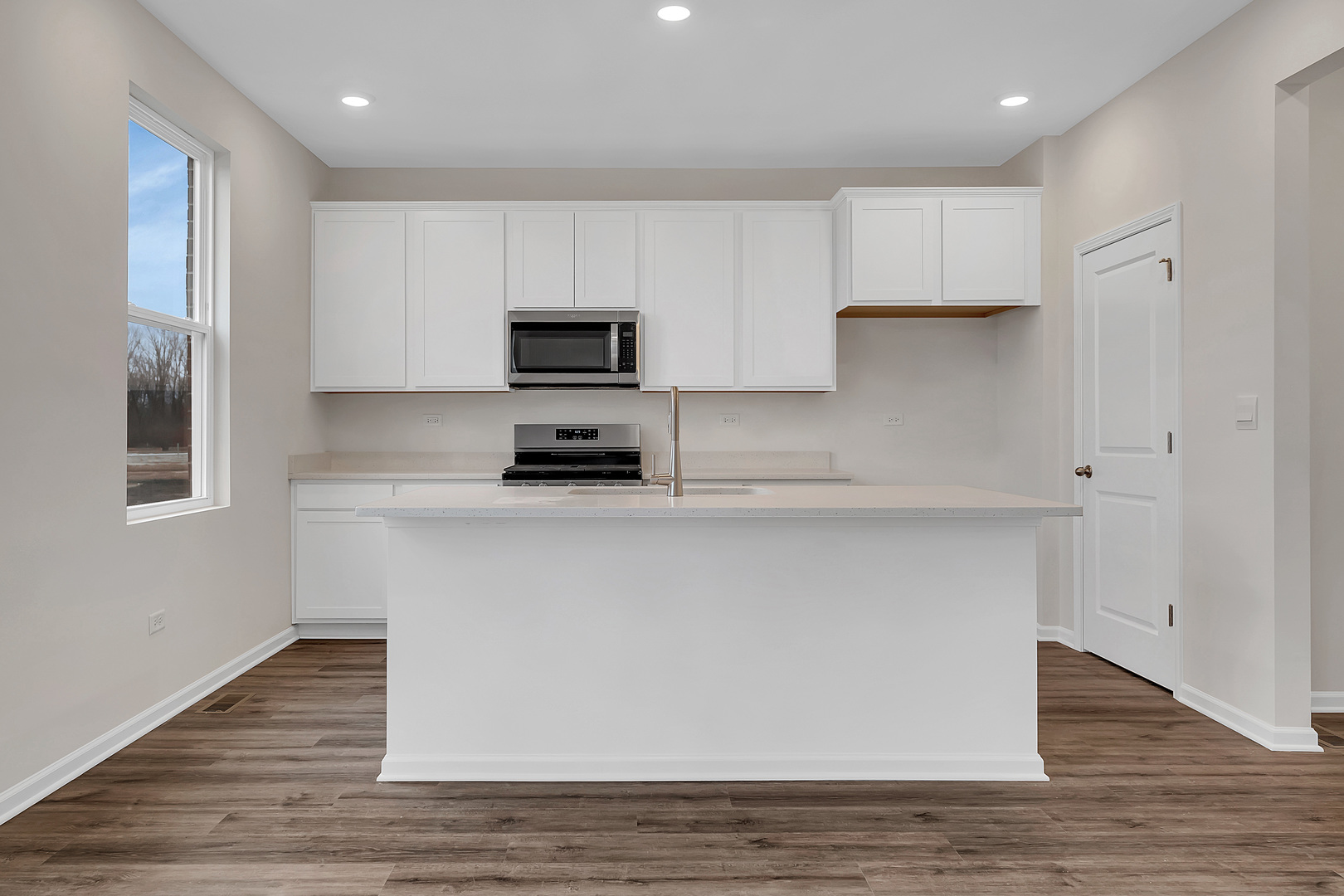 6720 Applegate Drive Plainfield, IL 60586 - Photo 8 of 17 a kitchen with kitchen island white cabinets and stainless steel appliances