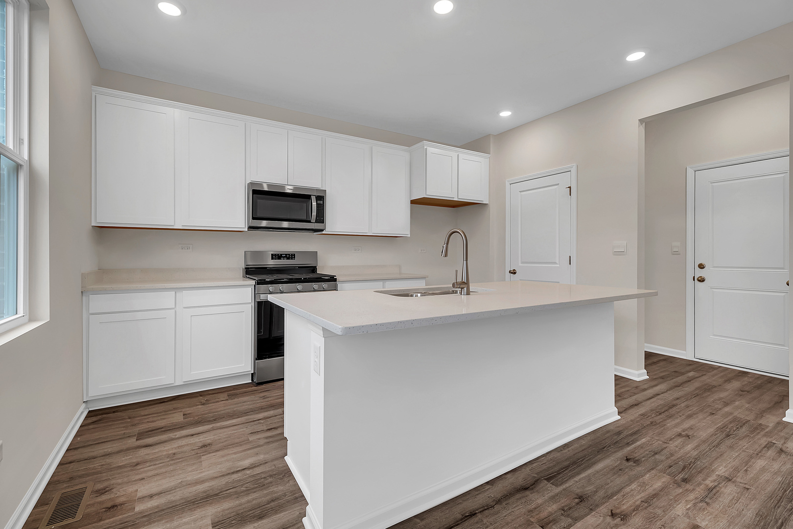 6720 Applegate Drive Plainfield, IL 60586 - Photo 9 of 17 a kitchen with granite countertop white cabinets and black appliances