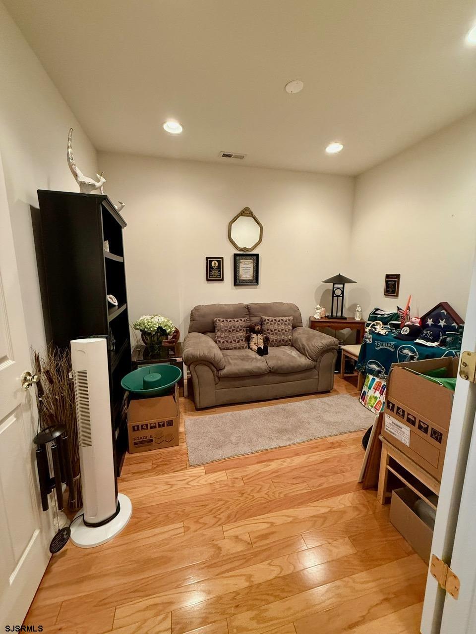 36 West Delray Lane Absecon, NJ 08201 - Photo 12 of 23 a living room with furniture a flat screen tv and a fireplace