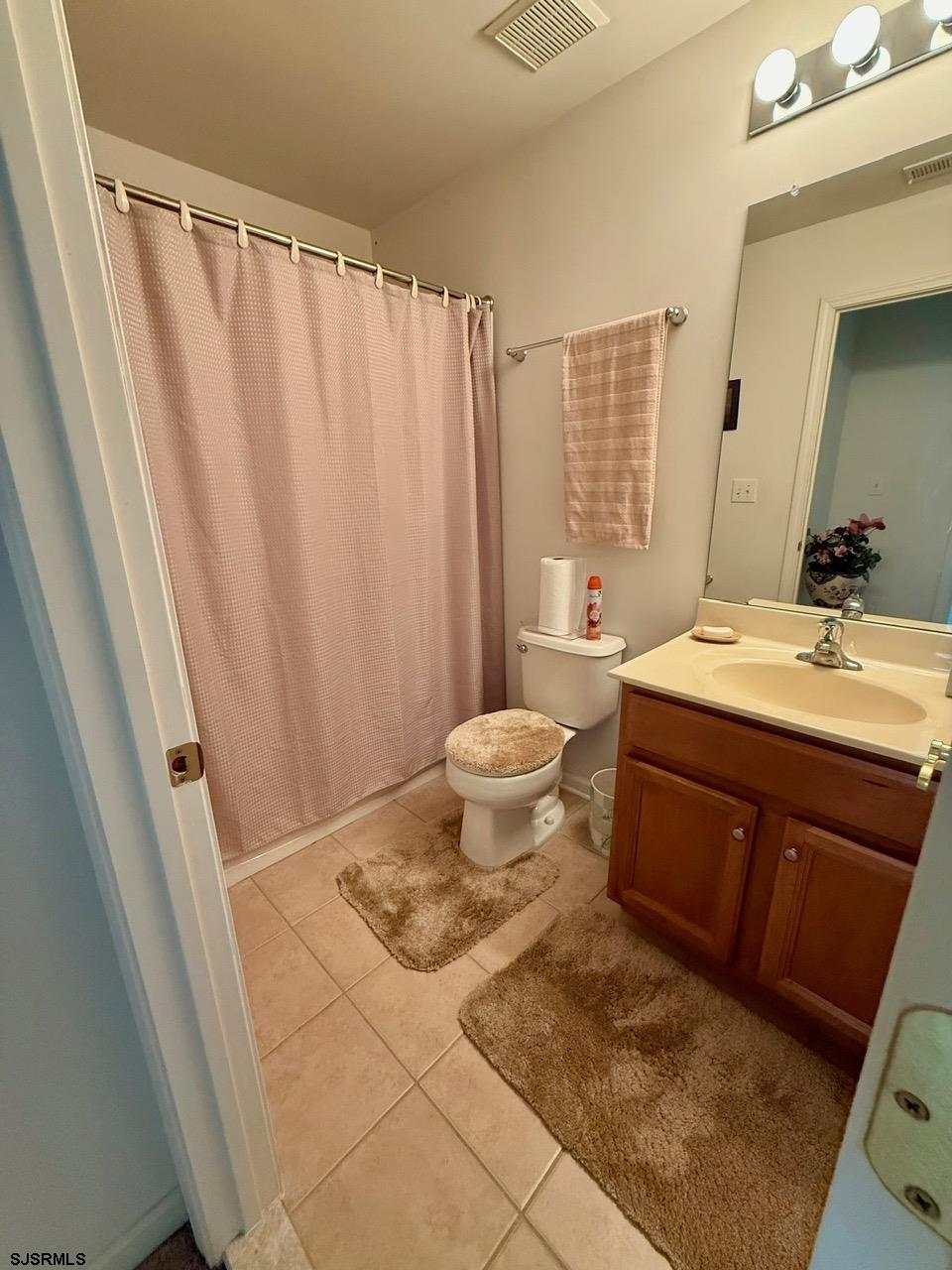 36 West Delray Lane Absecon, NJ 08201 - Photo 21 of 23 a bathroom with a sink a toilet and a mirror