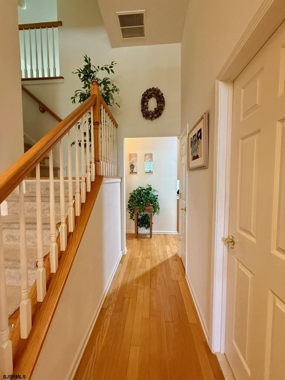 36 West Delray Lane Absecon, NJ 08201 - Photo 3 of 23 a view of a hallway with wooden floor and stairs