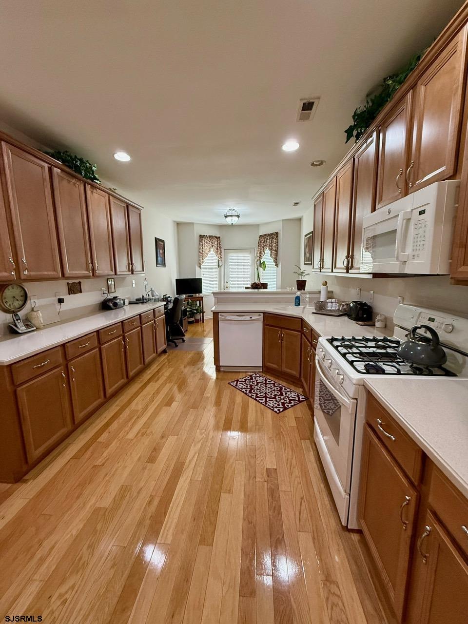 36 West Delray Lane Absecon, NJ 08201 - Photo 4 of 23 a large kitchen with stainless steel appliances granite countertop a stove a sink dishwasher and a refrigerator