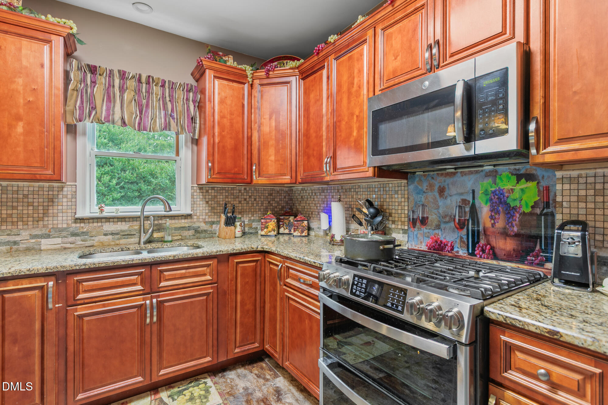 3163 Saul Loop Road Elon, NC 27244 - Photo 14 of 44 a kitchen with stainless steel appliances granite countertop a stove a sink and a microwave