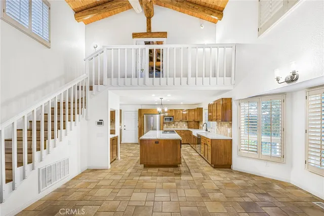 a kitchen with stainless steel appliances granite countertop a sink and a refrigerator